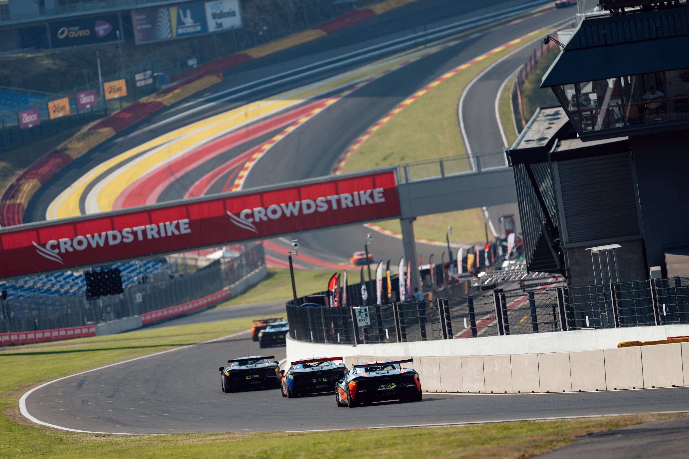 GT3 pack racing past the Spa-Francorchamps grandstands